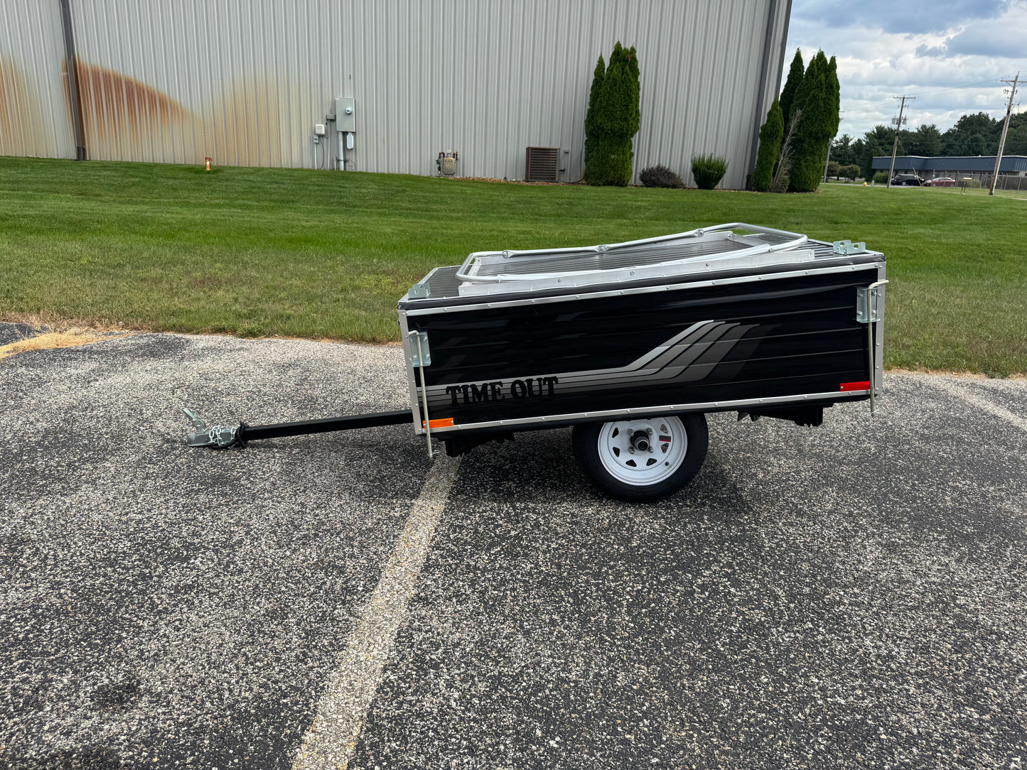 Small trailer with 'Time Out' branding on a paved surface.